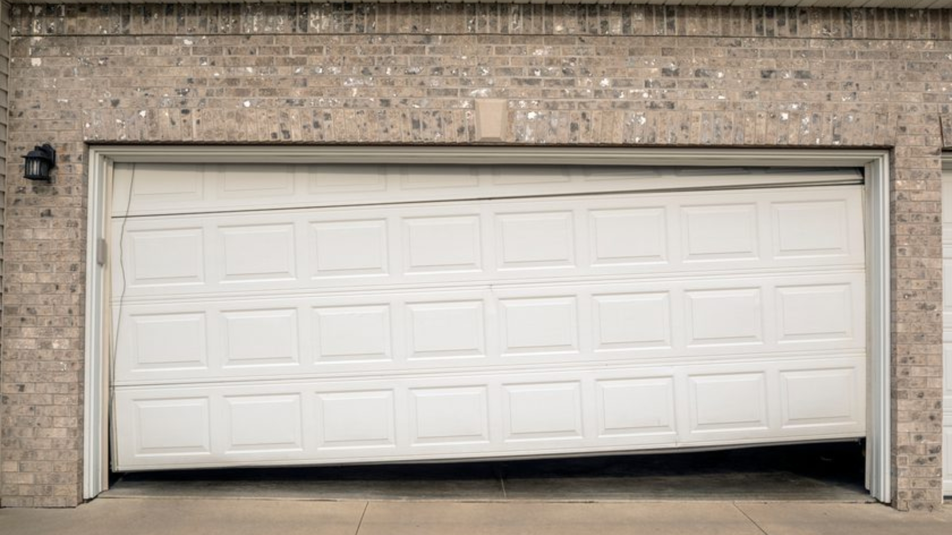 Misaligned garage door stuck at an angle.