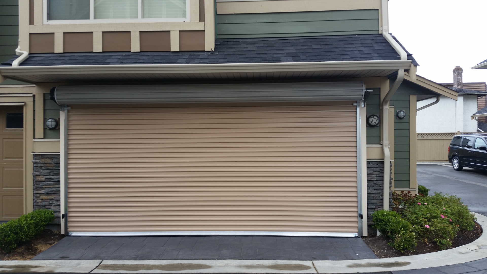 Overhead doors in neutral tone on a home's attached garage