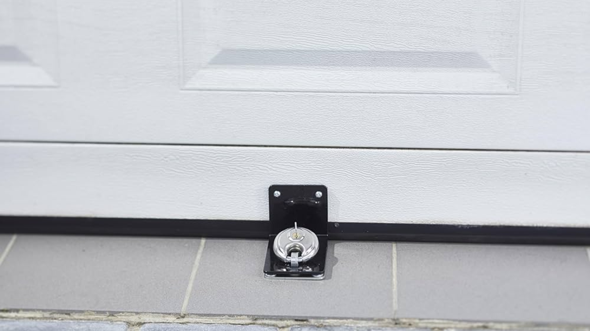 Close-up of a lock mechanism installed for garage door security.