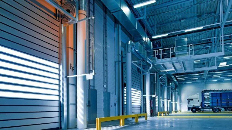 High-clearance commercial garage area featuring several door openings.