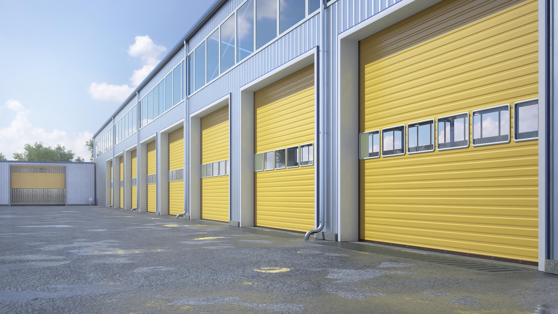 Warehouse with multiple yellow roll up doors and glass windows.