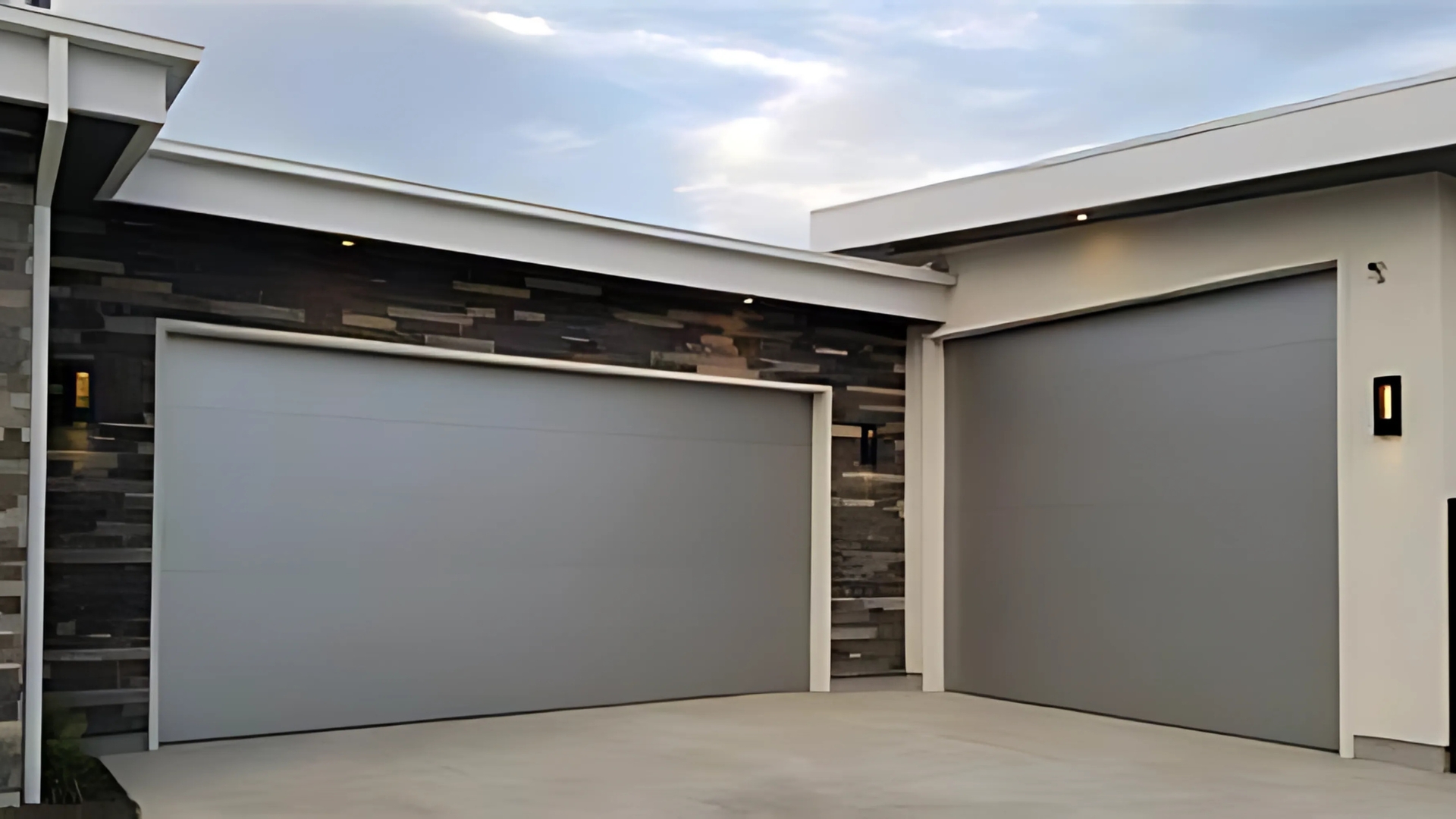 Modern steel garage door with a sleek, minimalist design in a matte gray finish