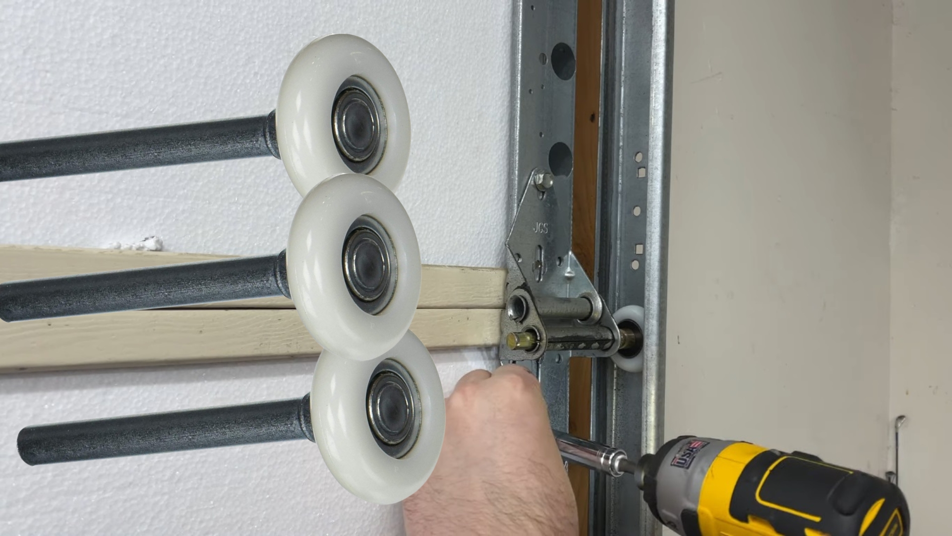 Fixing a noisy garage door with durable nylon rollers