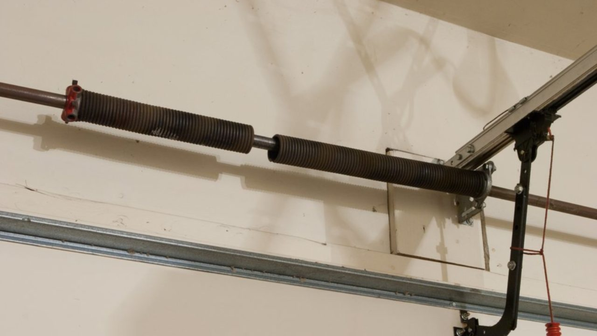 A broken torsion spring requires urgent garage spring repair.