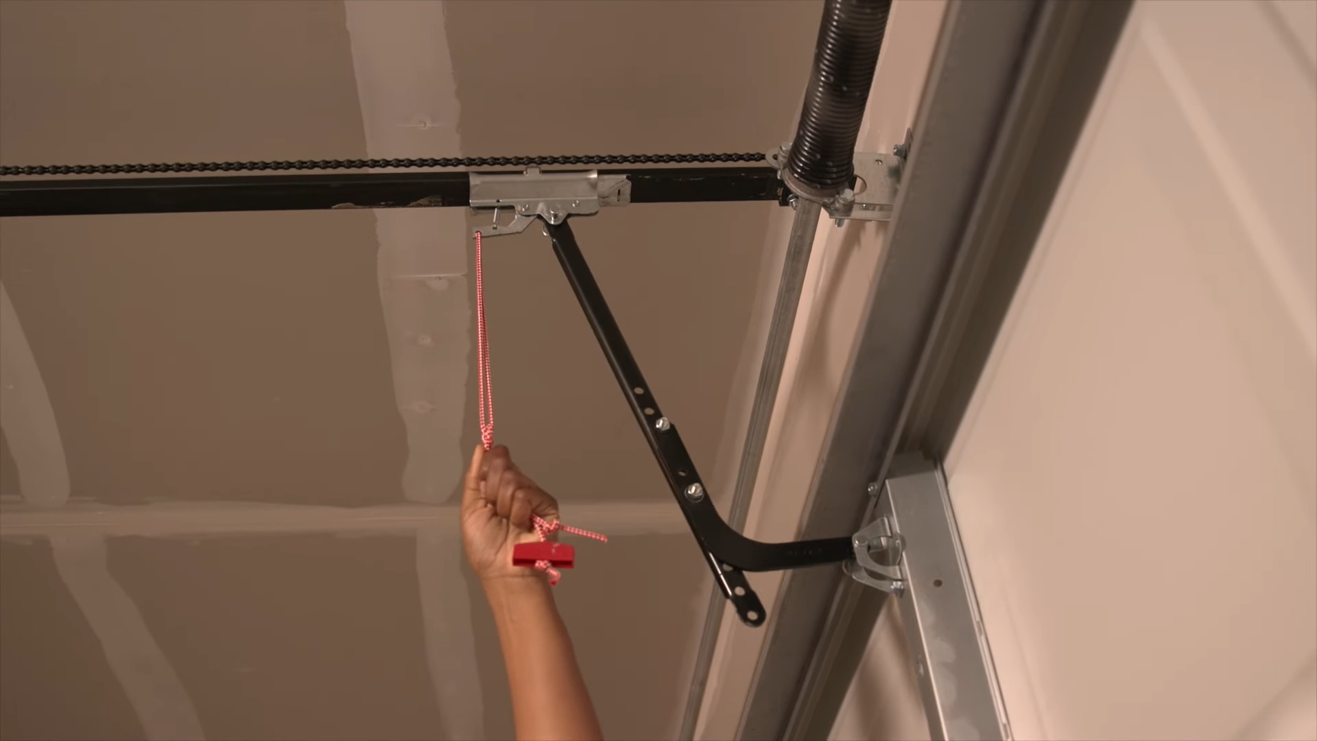 Manually opening garage door with red release cord